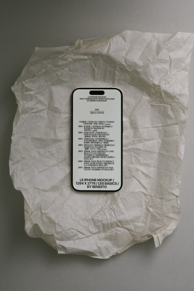 iPhone mockup with cream screen on wrinkled paper displaying Le iPhone Mockup content