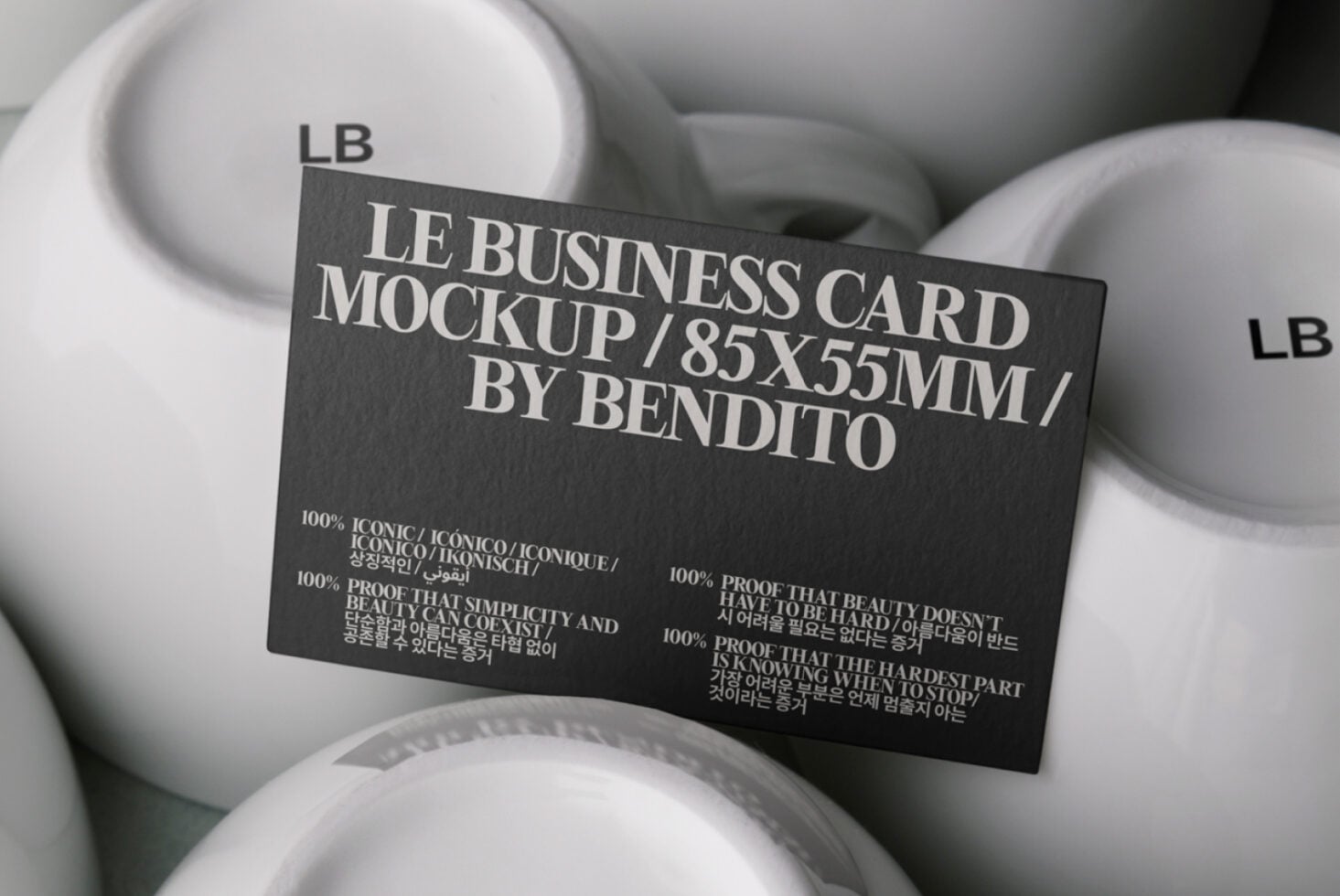 Dark charcoal business card mockup displayed on white ceramic bowls