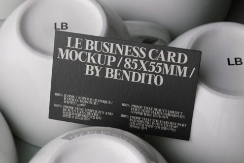 Dark charcoal business card mockup displayed on white ceramic bowls