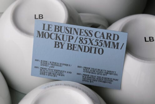 Light blue business card mockup resting on stacked white ceramic bowls
