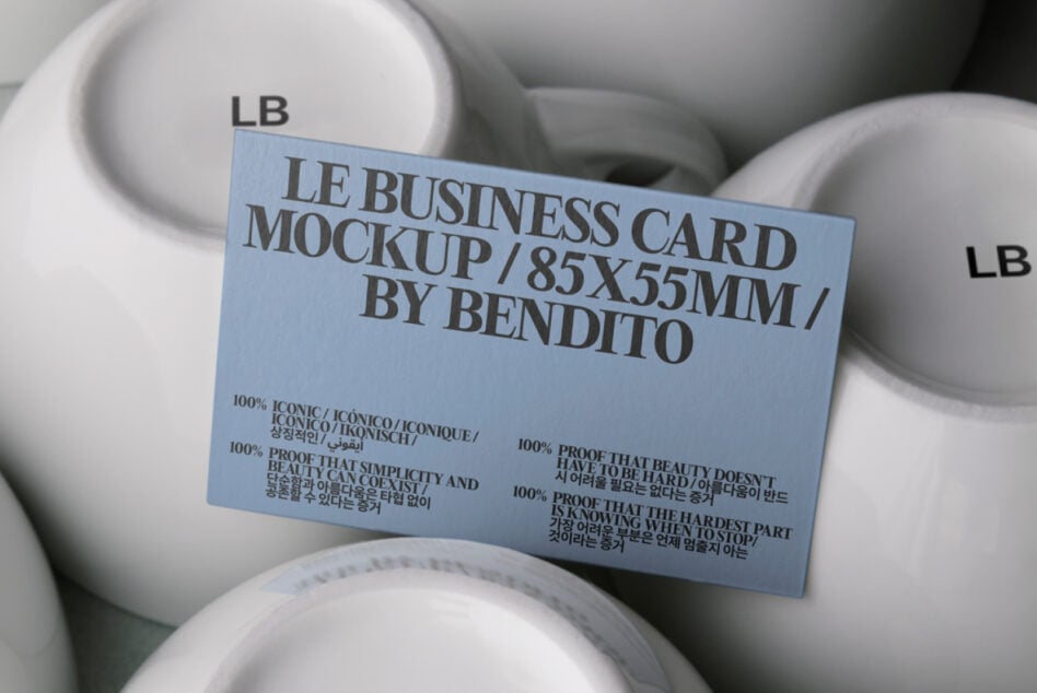 Light blue business card mockup resting on stacked white ceramic bowls
