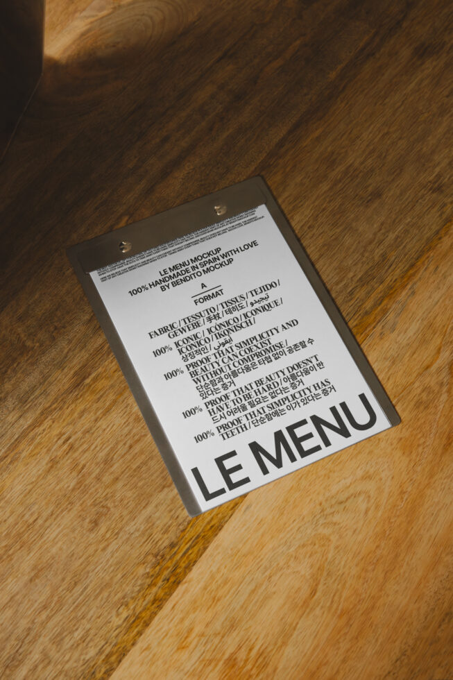 Hanging menu mockup shot angled on wooden floor with fabric texture