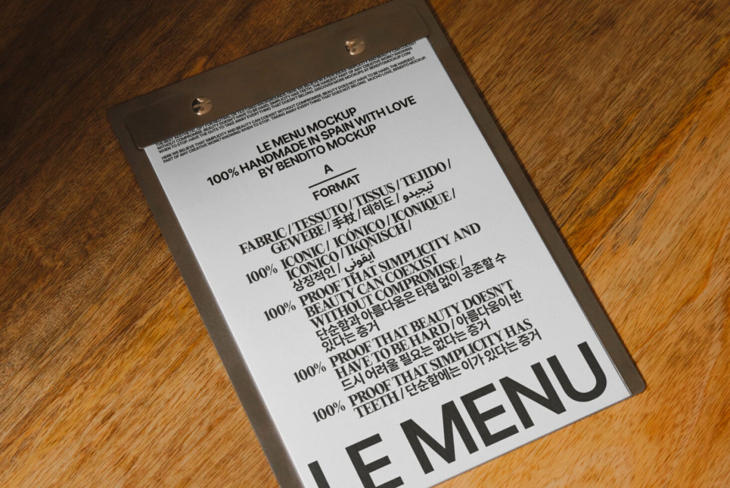White menu mockup hanging from clips displaying multilingual content on timber