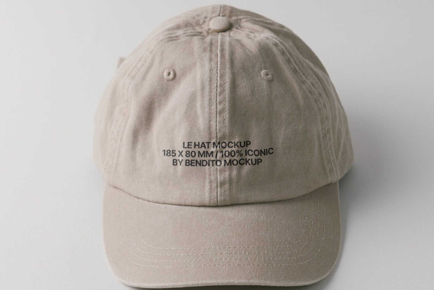 Cream colored cap overhead view with small embroidered text visible