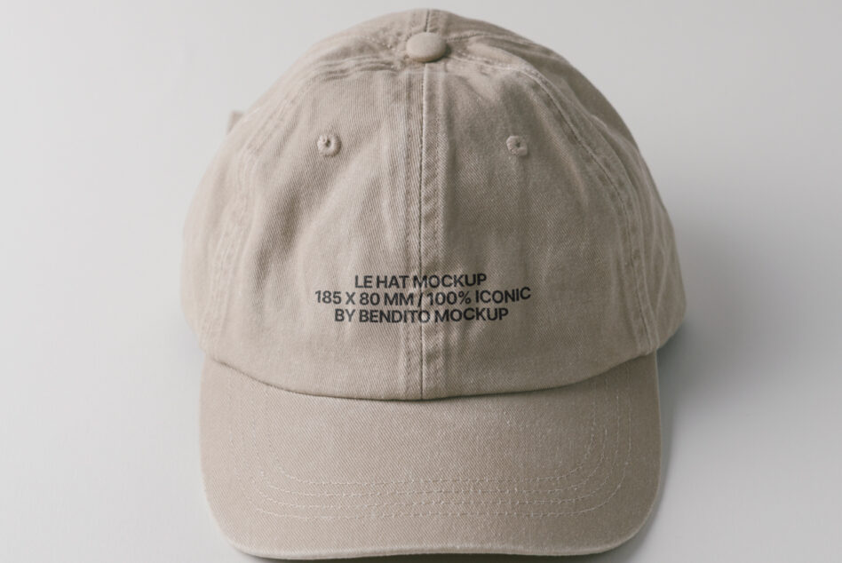 Cream colored cap overhead view with small embroidered text visible