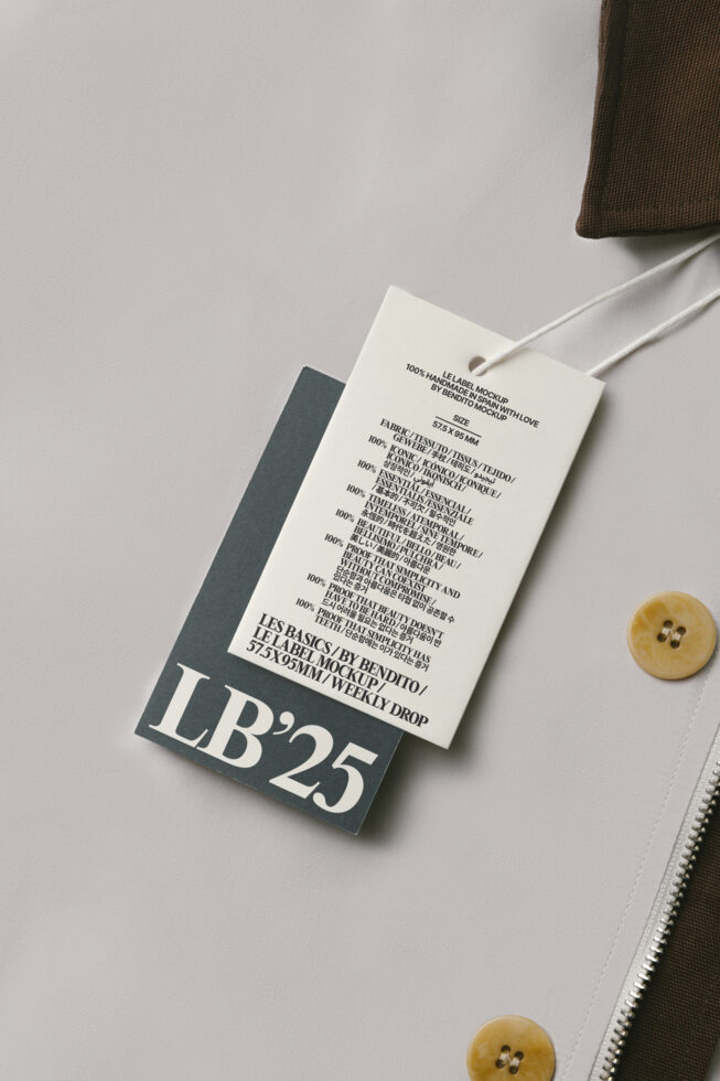 Cream hang tag with dark charcoal backing on neutral fabric with buttons