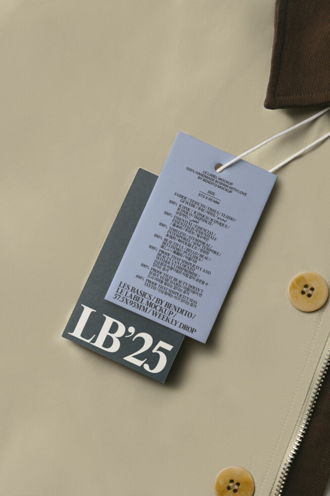 Periwinkle hang tag with dark charcoal backing on neutral fabric with buttons