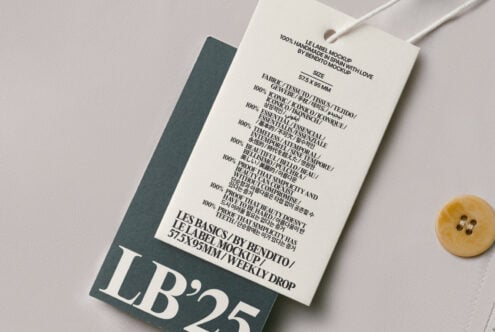 Cream hang tag with multilingual care text on charcoal backing styled flat