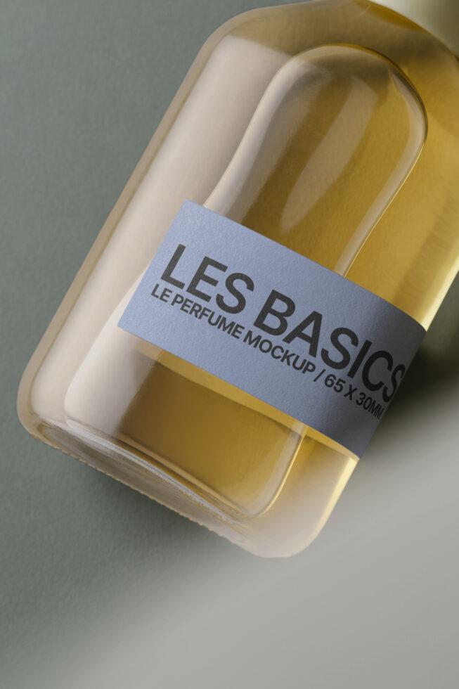 Golden perfume bottle with blue label in cream colored box, angled view