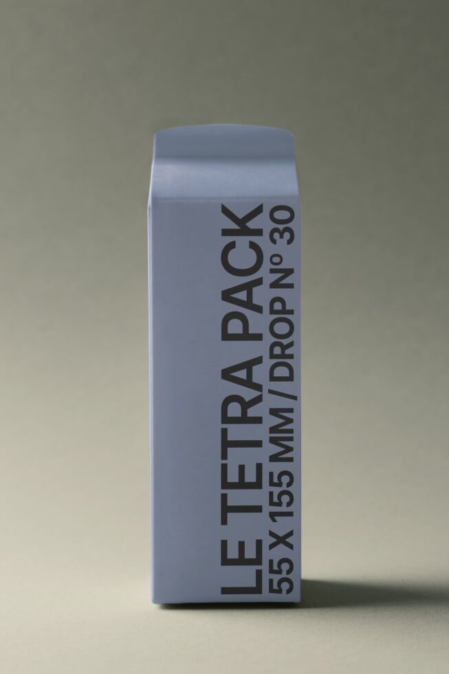 Light blue rectangular tetra pack mockup with vertical text layout