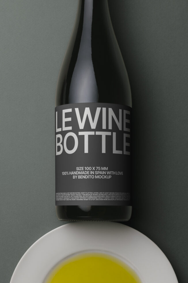 Dark wine bottle label mockup with white bowl of liquid below on grey surface
