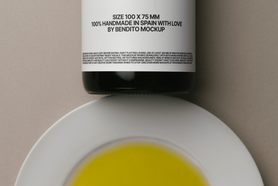 Olive oil bottle with white label showing handmade details, shot from above