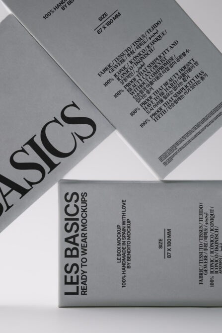 Overhead shot of black, white, gray clothing tags fanned out with product specs