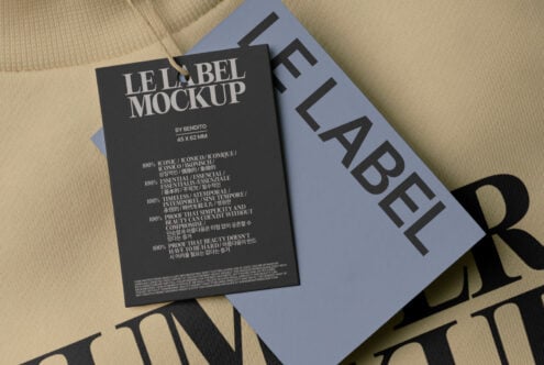 Label mockup on beige clothing with black label tag in overhead shot