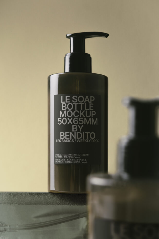 Dark pump bottle with white label on warm beige surface background