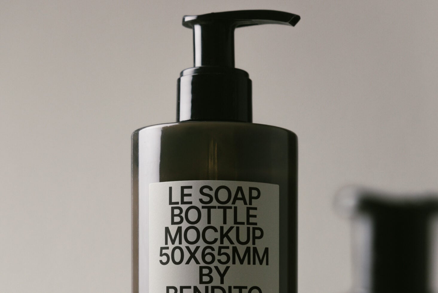 Black push pump bottle on soft neutral surface with clean aesthetic