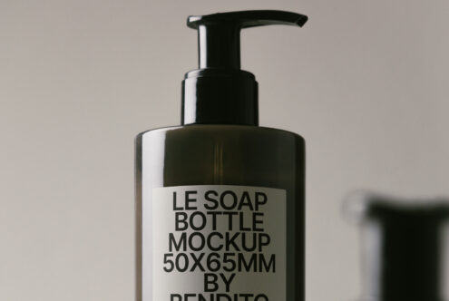 Black push pump bottle on soft neutral surface with clean aesthetic