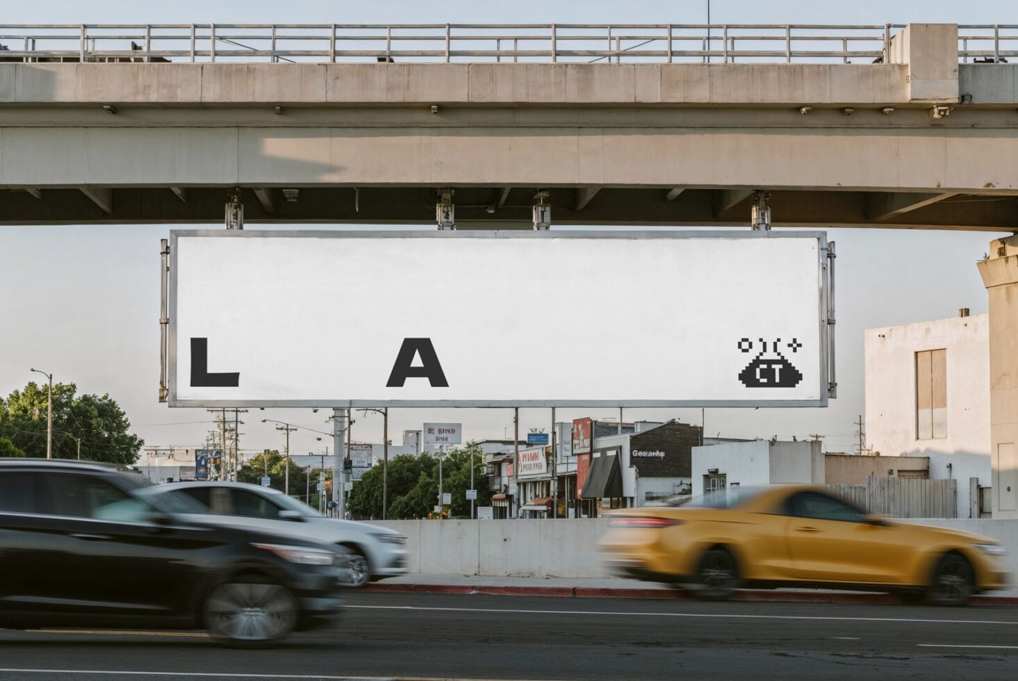Underpass billboard showing retro ET movie poster with LA text, palm trees