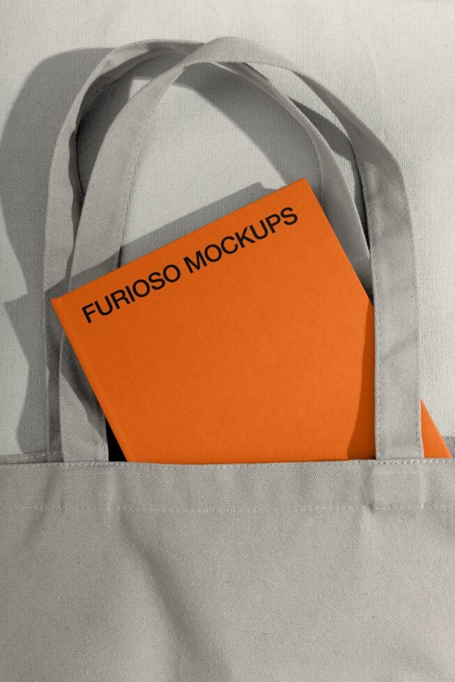 Orange branded shopping bag nestled in cream canvas tote