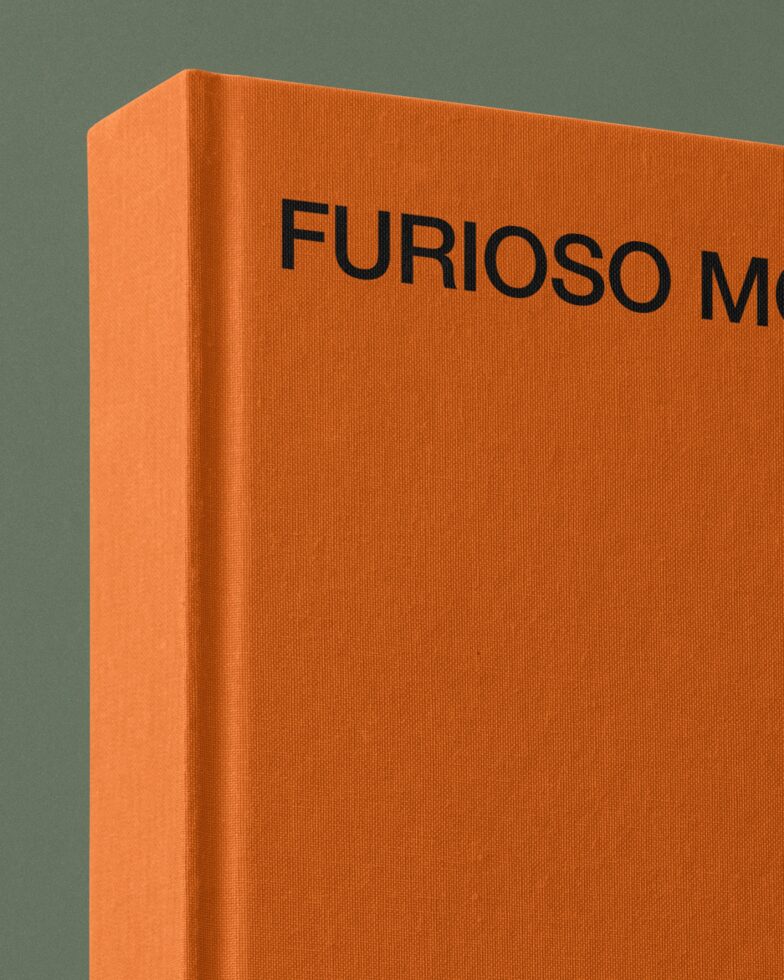 Side view of thick orange hardcover book mockup against teal background