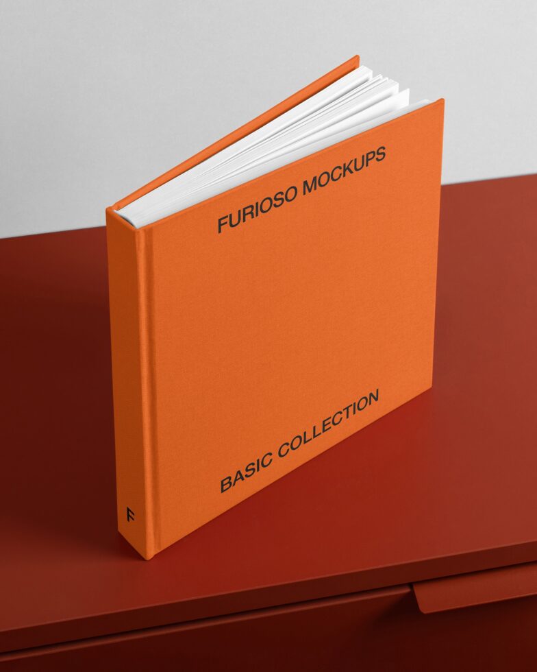Orange hardcover book with white pages fanned open on red background