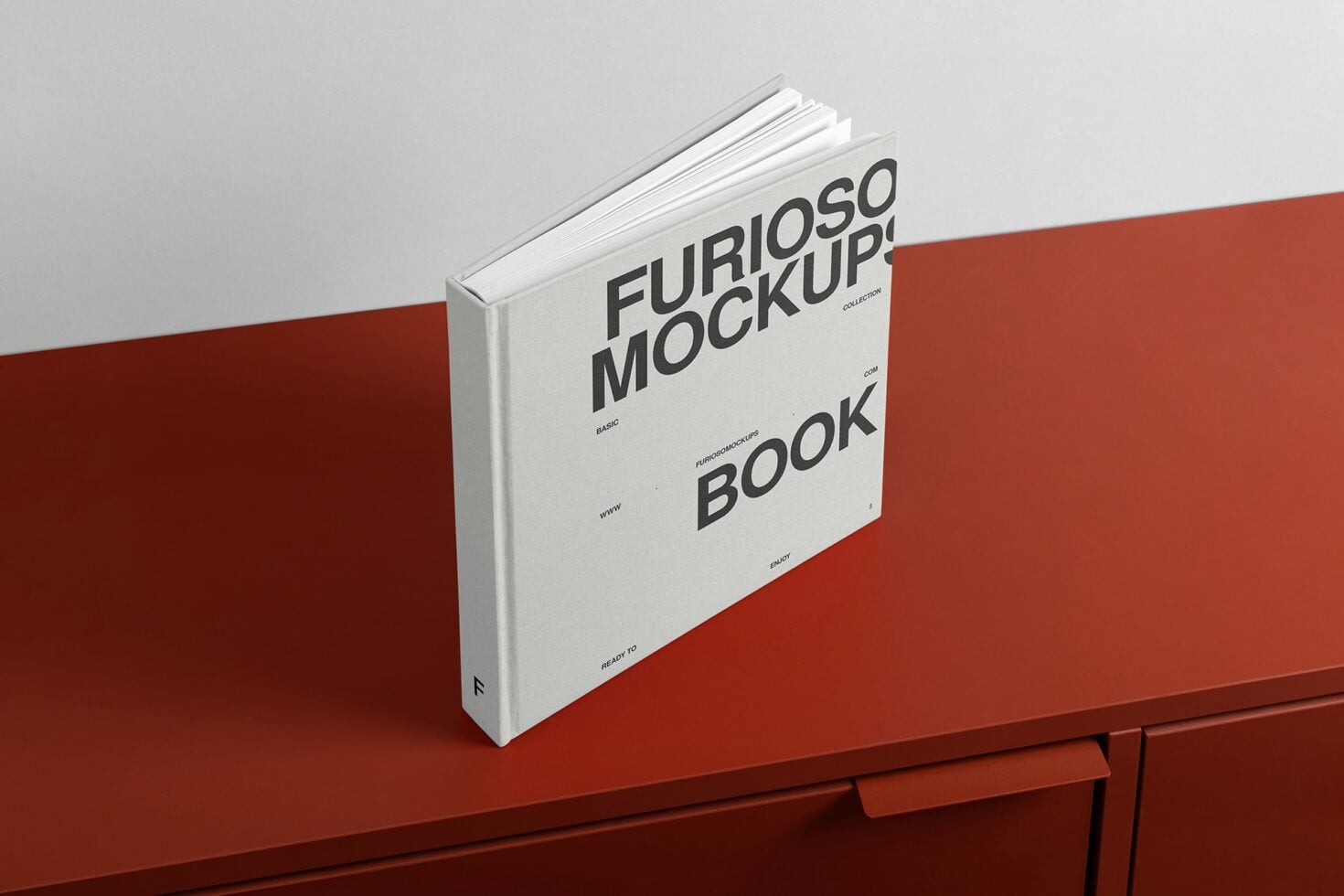White hardcover book with Furioso Mockups branding on red surface