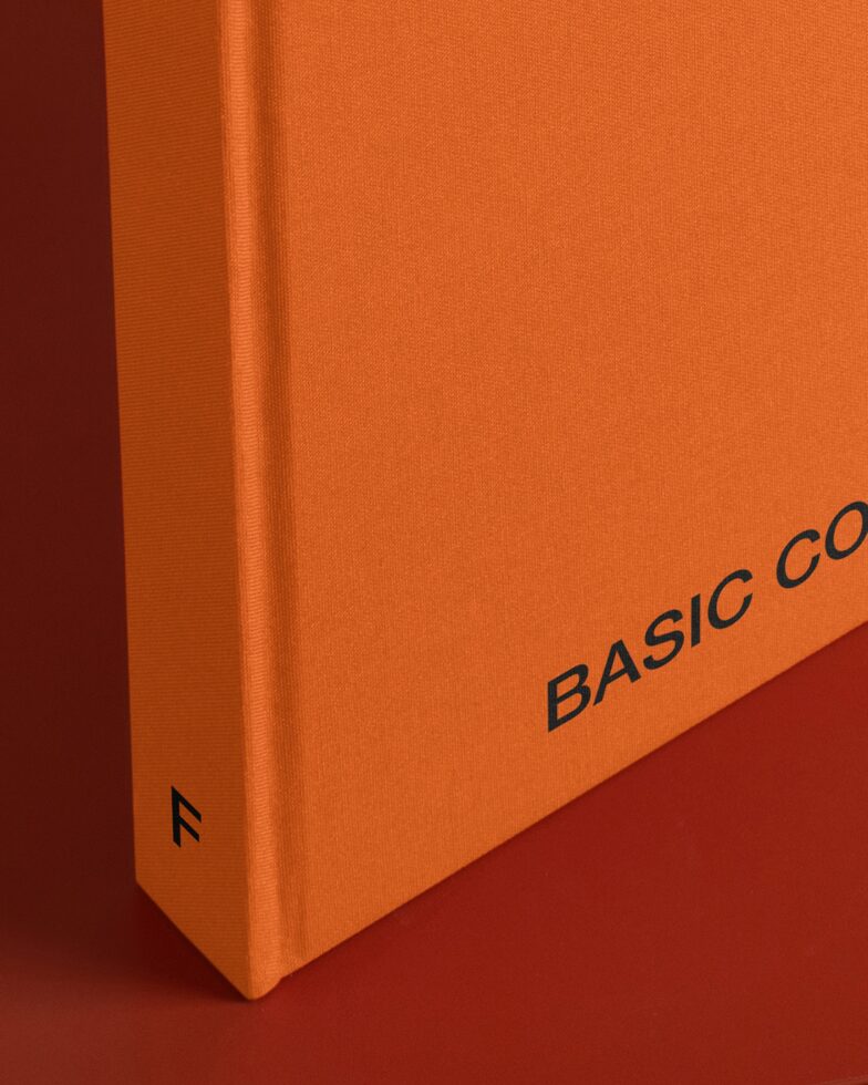 Close up of orange hardcover book spine with Basic Collection text