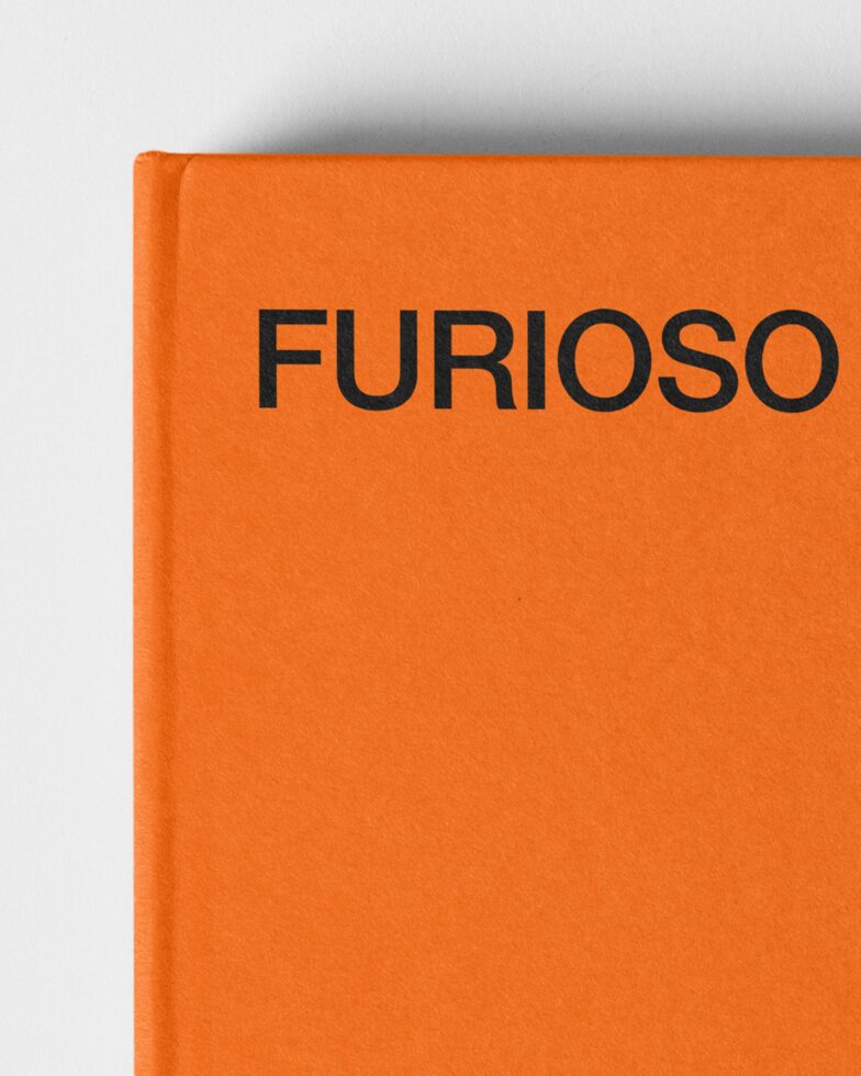 Orange hardcover book spine showing Furioso branding in black text