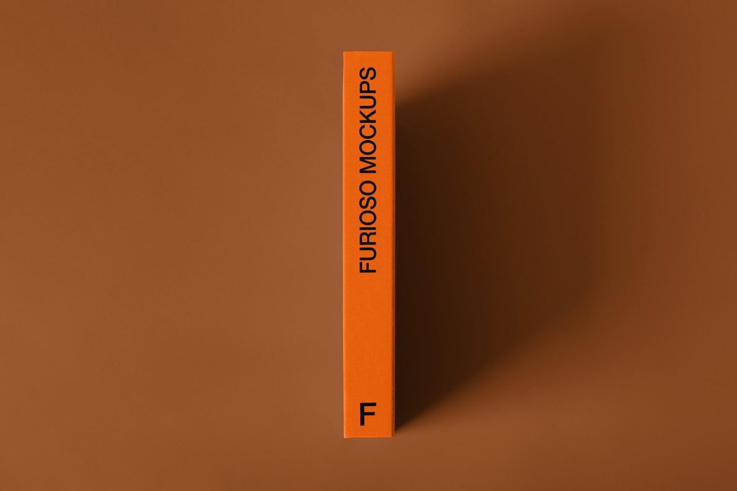 Bright orange vertical box with black text Furioso Mockups on brown background with shadow