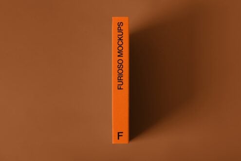 Bright orange vertical box with black text Furioso Mockups on brown background with shadow