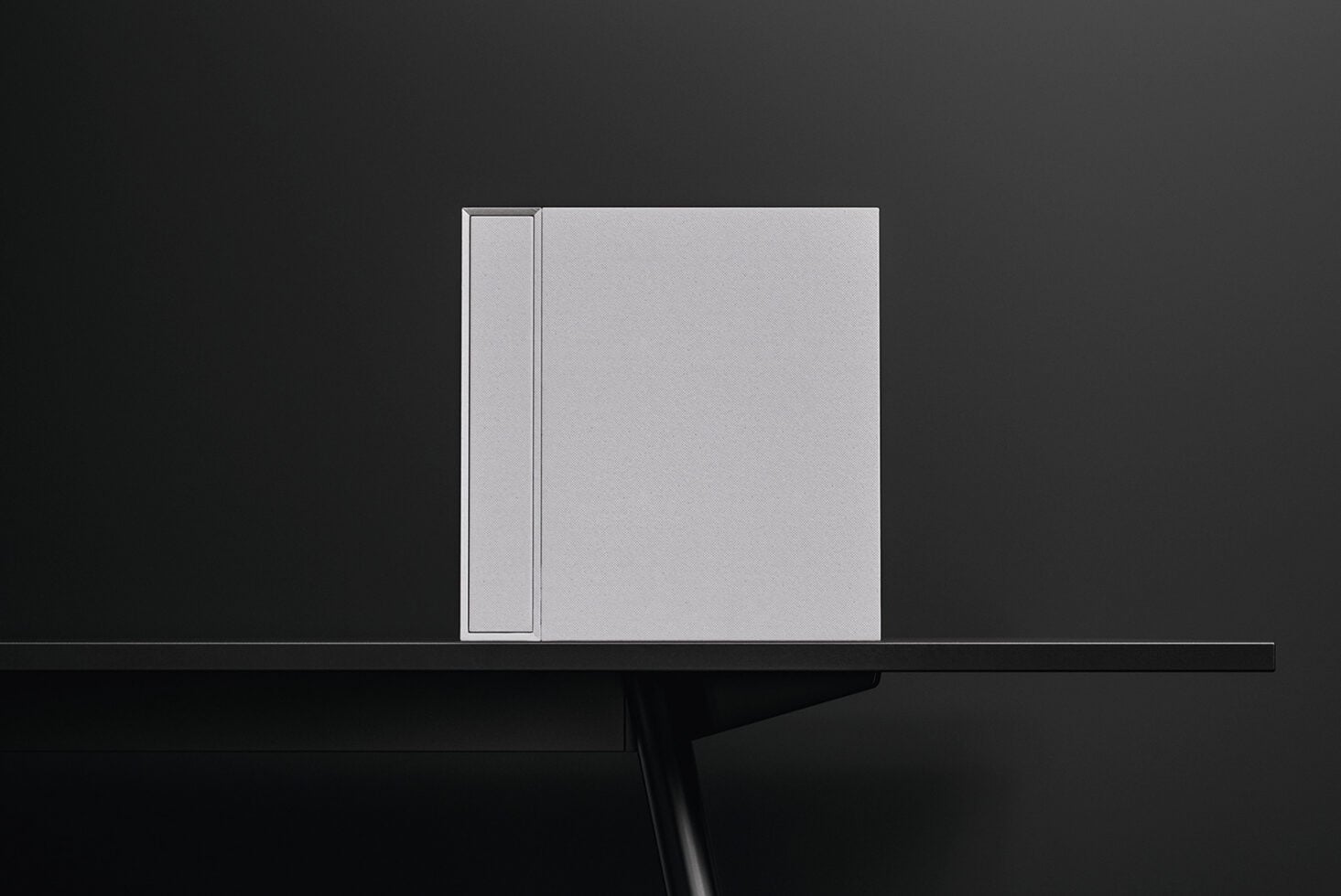 Blank hardcover book mockup with dust jacket, front view on dark surface