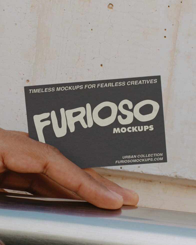 Hand holding dark business card with cream FURIOSO text mockup