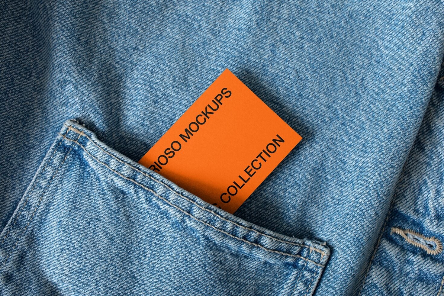 Orange square card peeking from denim pocket with mockup text