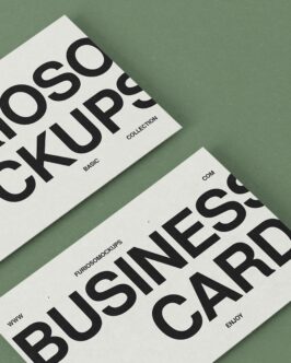 Two cream mockups angled on sage green background flat lay