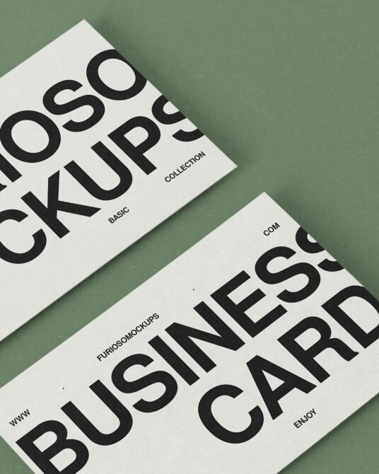 Two cream mockups angled on sage green background flat lay