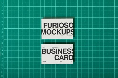White business card mockups on teal grid background flat lay