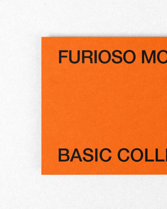 Orange card corner detail on white background showing cropped black text