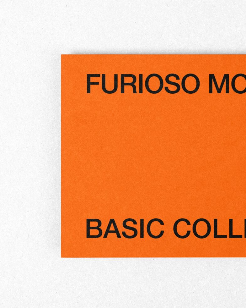 Orange card corner detail on white background showing cropped black text