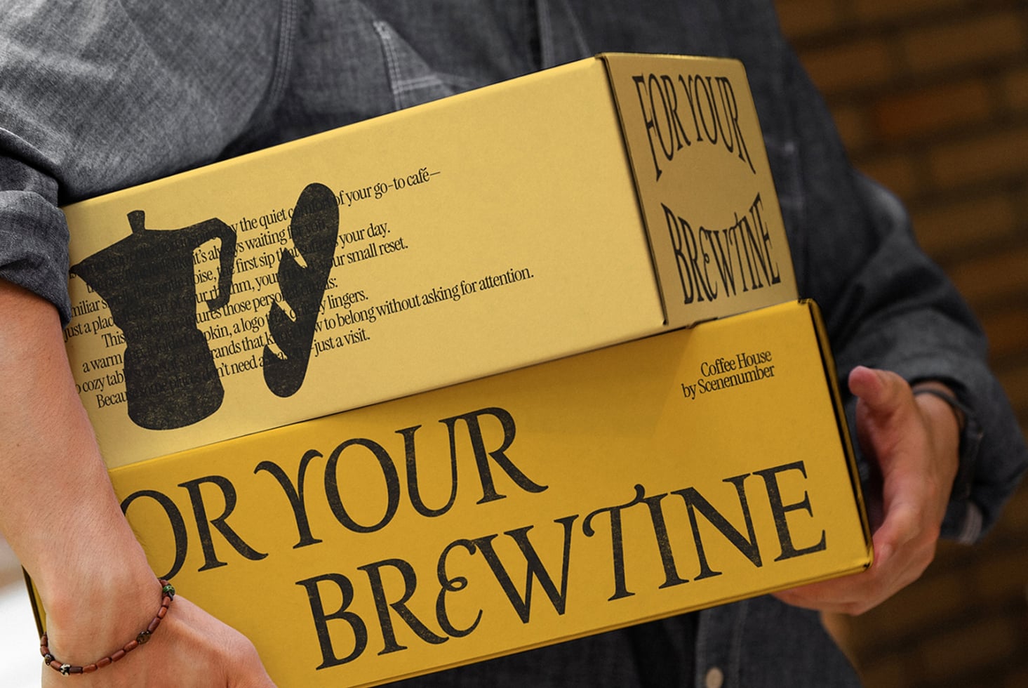 Yellow branded box FOR YOUR BREW with cat cup design, hands holding