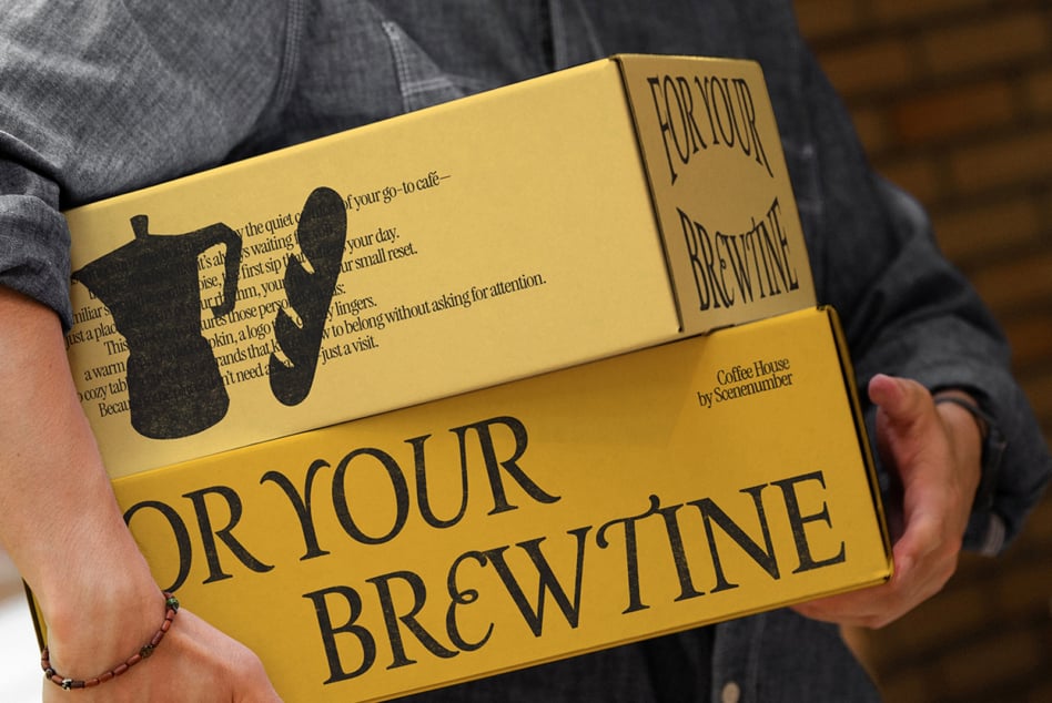Yellow branded box FOR YOUR BREW with cat cup design, hands holding