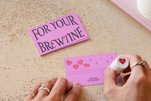 Pink punch card labeled 'For Your Brew Time' with red heart-shaped punch tool