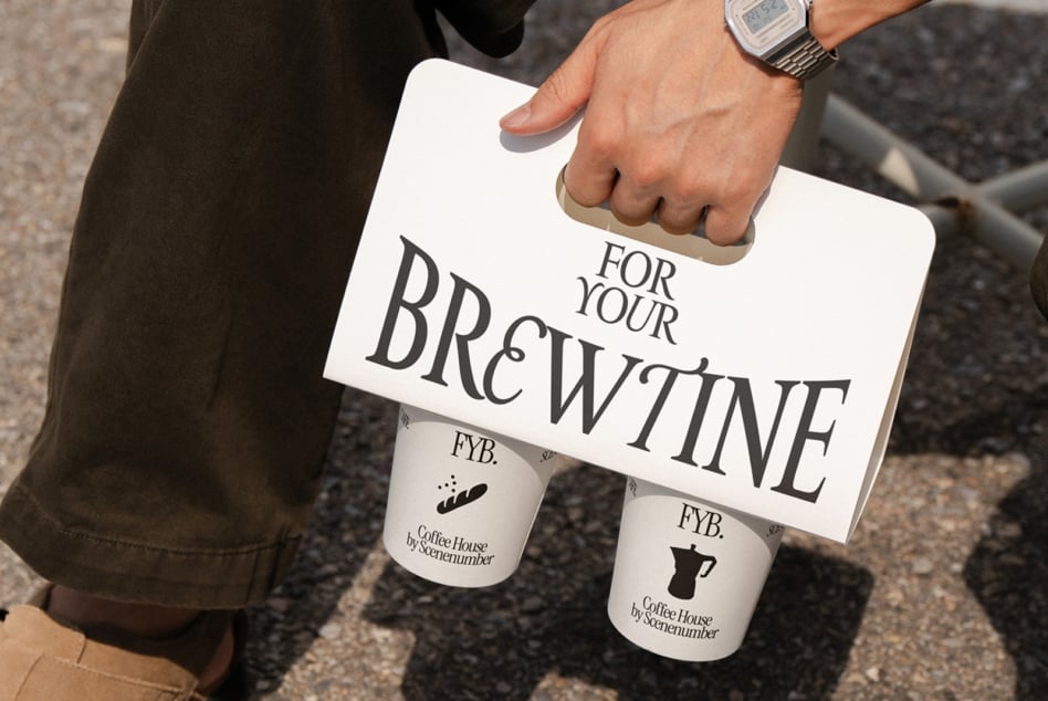 White coffee holder mockup held by hand showing typography with two branded cups