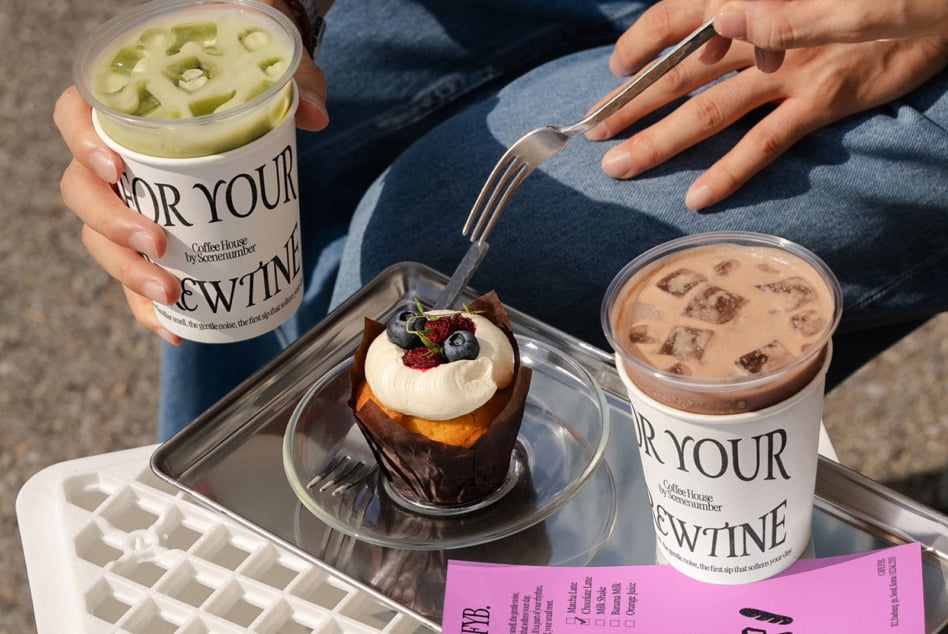 Coffee shop spread with iced drinks, chocolate pastry, FYB menu on table