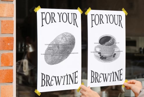 Two taped posters on storefront displaying grayscale dotted bread shapes with For Your Brewtine