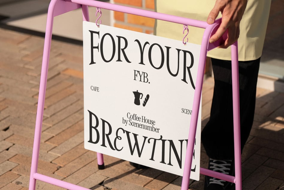 Pink A-frame with coffee house sign mockup displayed on brick pavement