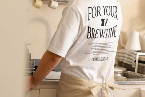 White tee with brewpub graphic design mockup displayed on person indoors