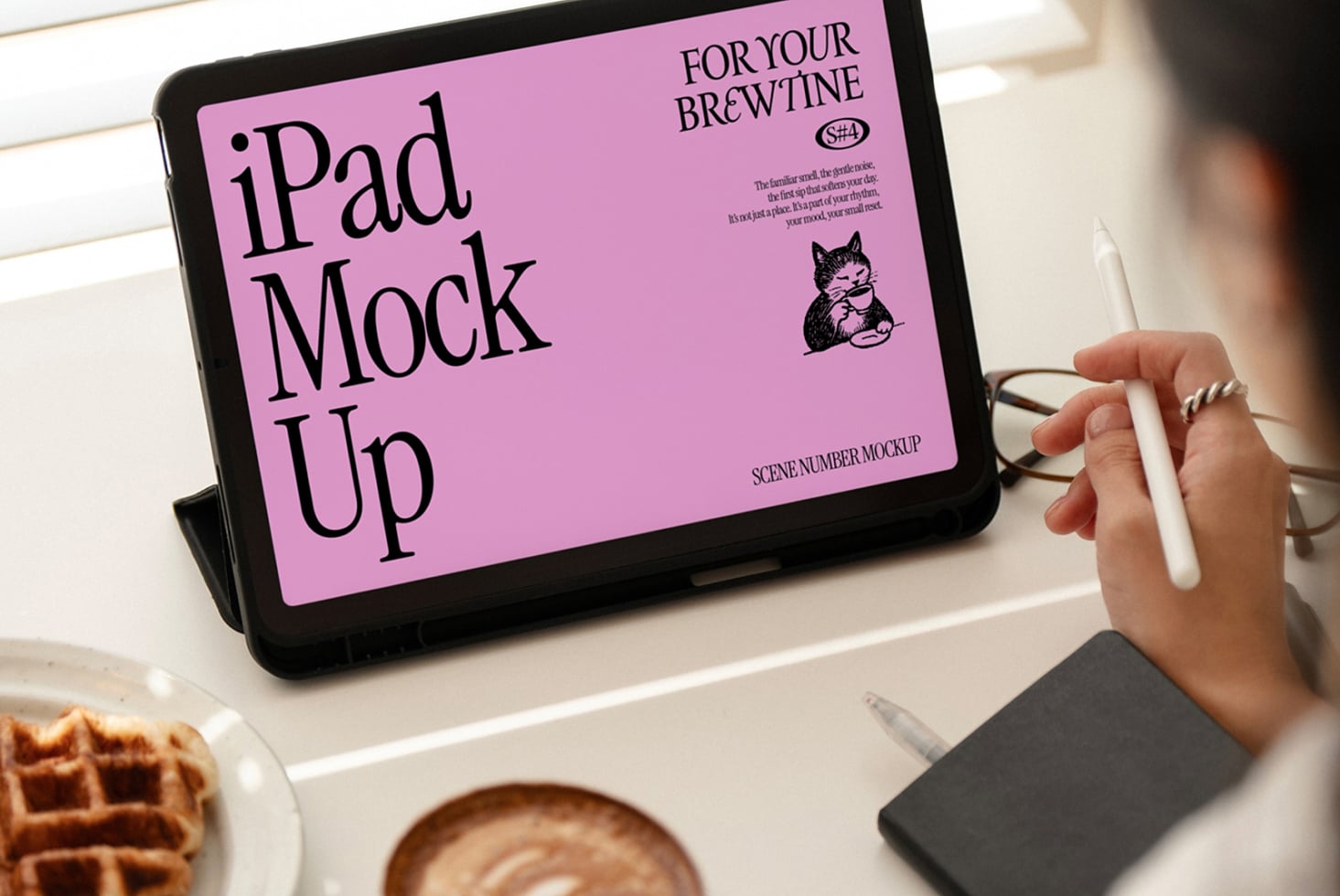 iPad landscape mockup with pink screen, coffee cup visible, hand holding stylus