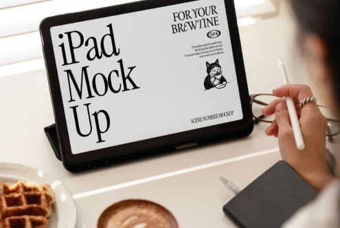 iPad showing cafe design mockup on desk with coffee cup nearby