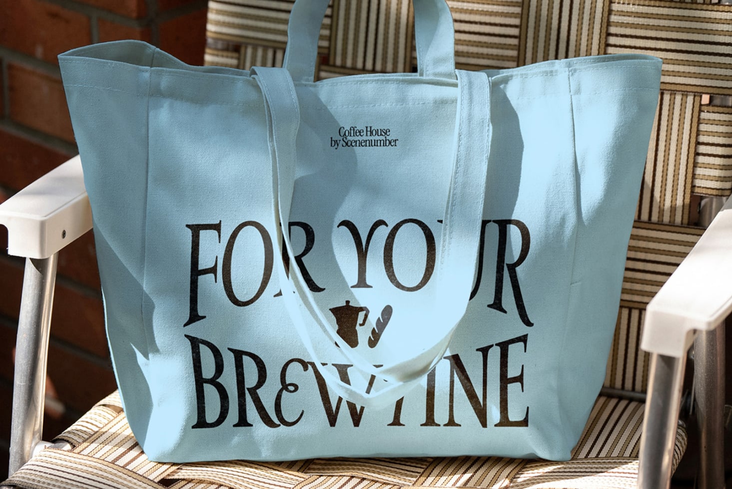Light blue tote bag with For Your Brew Wine text on striped chair