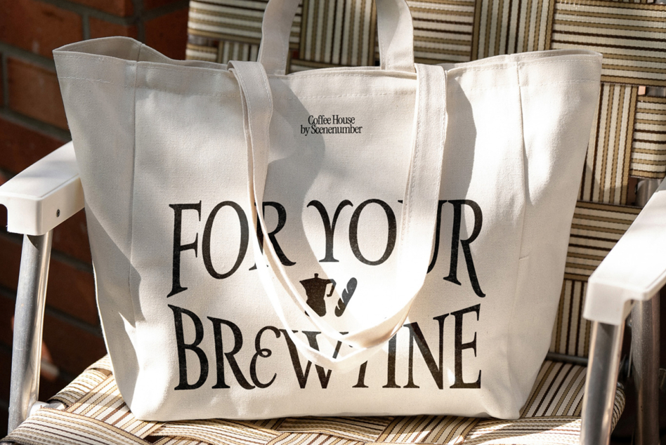 Large cream tote with For Your Brewtine typography sitting on striped chair